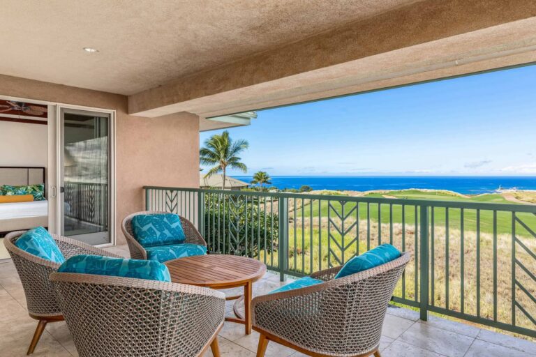 Stunning ocean view from the condo balcony, showcasing waves and a clear blue sky.