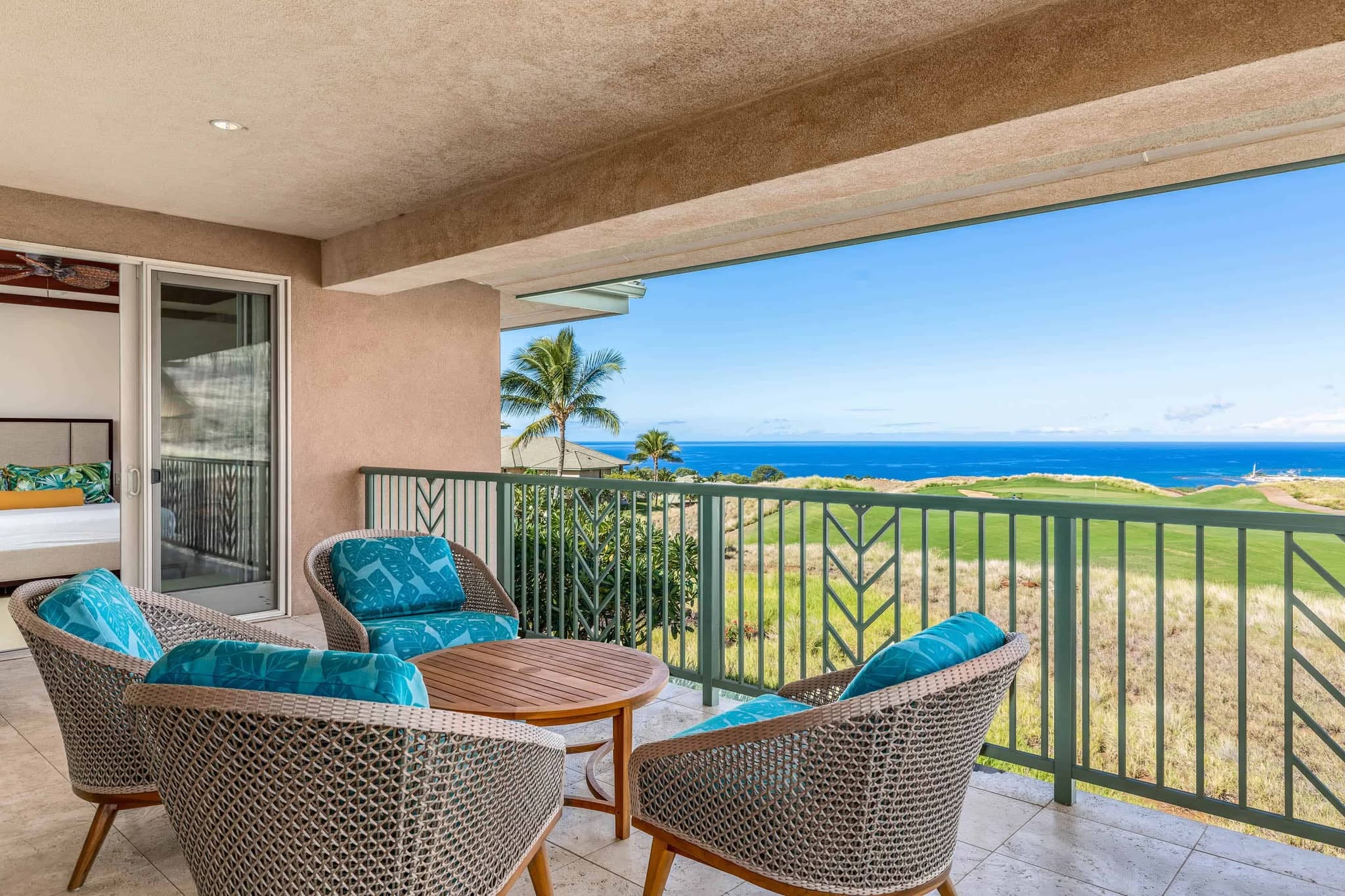 Stunning ocean view from the condo balcony, showcasing waves and a clear blue sky.