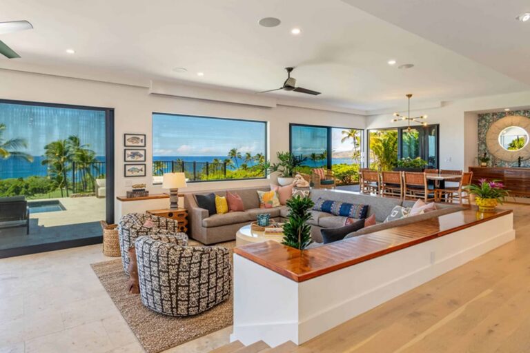 A cozy living room featuring a large window with a stunning view of the ocean.