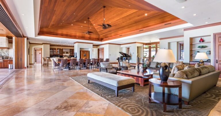 Spacious living room featuring a dining area and a grand piano, creating a warm and inviting atmosphere.